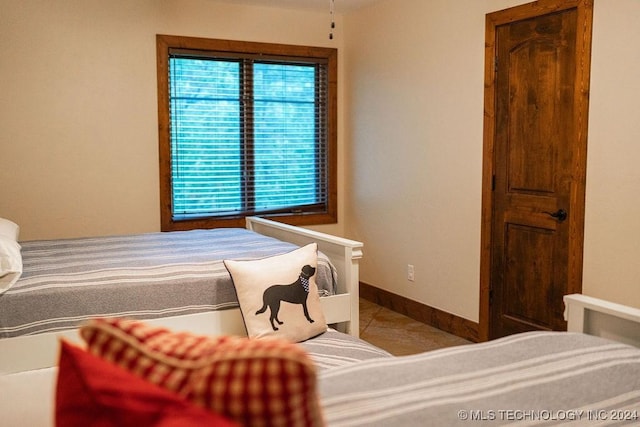 tiled bedroom with baseboards