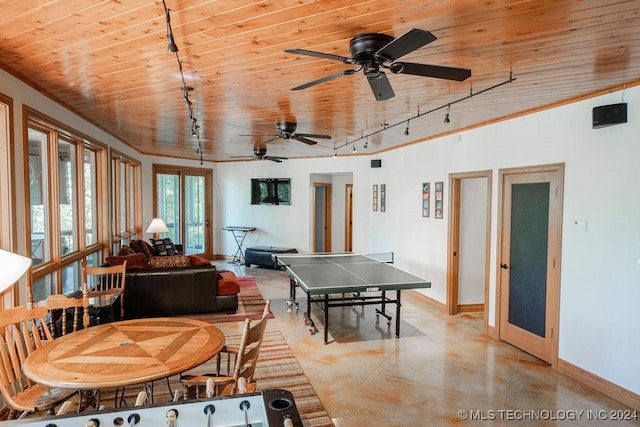 playroom featuring concrete flooring, wood ceiling, rail lighting, and baseboards