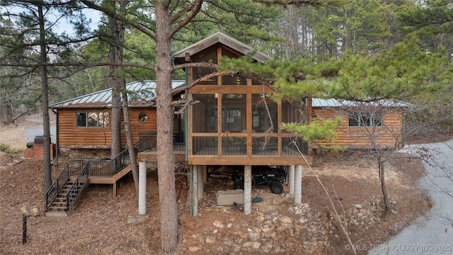 view of playground with a sunroom and stairway