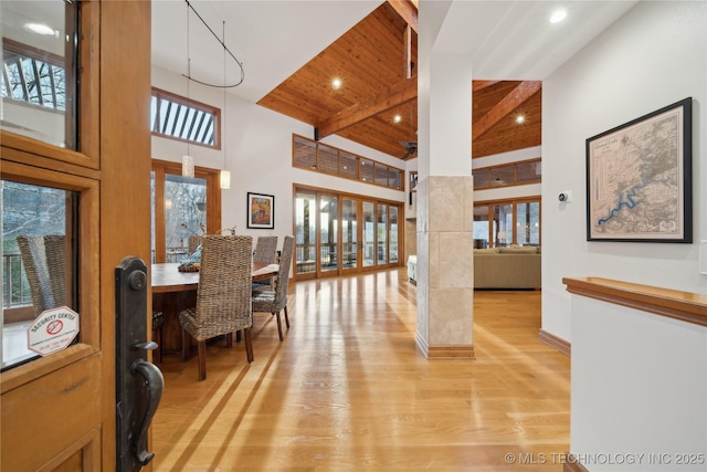 office space featuring high vaulted ceiling, wooden ceiling, recessed lighting, light wood-type flooring, and beam ceiling