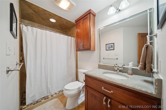 bathroom featuring a shower with shower curtain, visible vents, toilet, and vanity