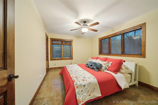 bedroom with a ceiling fan and baseboards