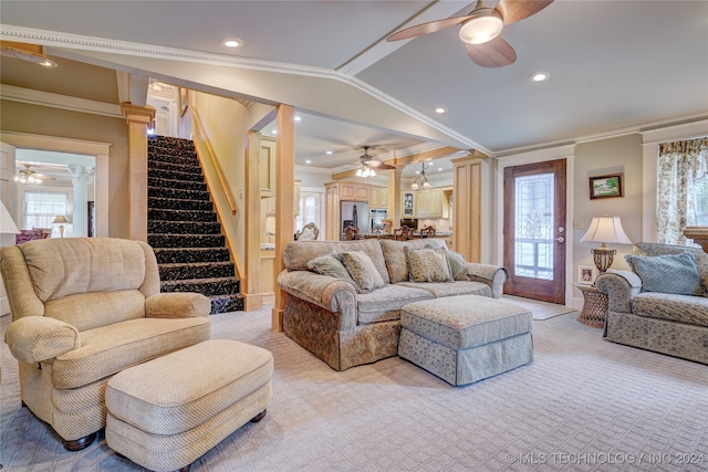 carpeted living room with ornamental molding, ceiling fan, vaulted ceiling, and ornate columns