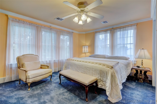 carpeted bedroom featuring multiple windows, ceiling fan, and crown molding