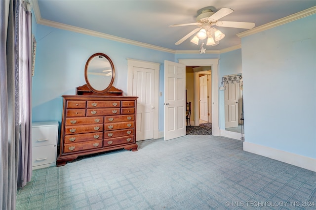 carpeted bedroom featuring ornamental molding and ceiling fan