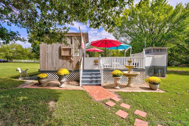 view of play area with a wooden deck and a yard