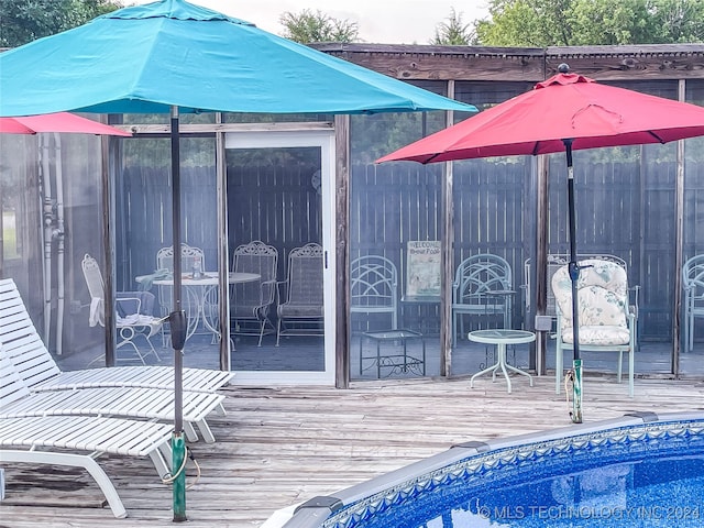 view of swimming pool with a deck