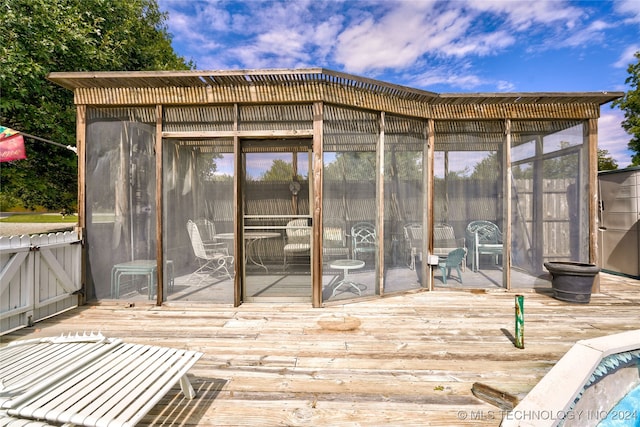 wooden deck with a sunroom