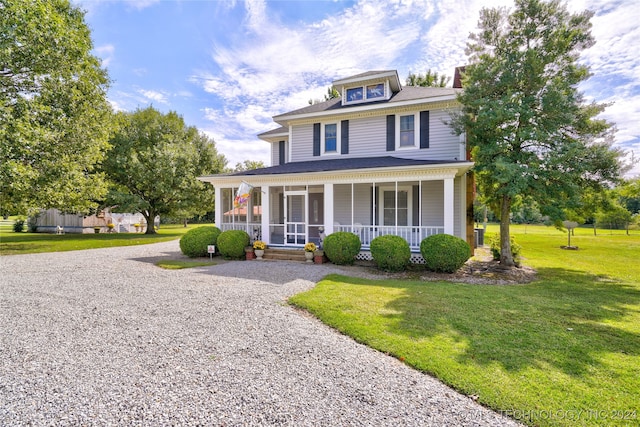 view of front of house with a front yard and a porch