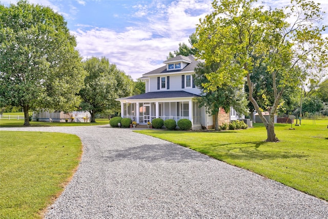 view of front facade featuring a front lawn and covered porch