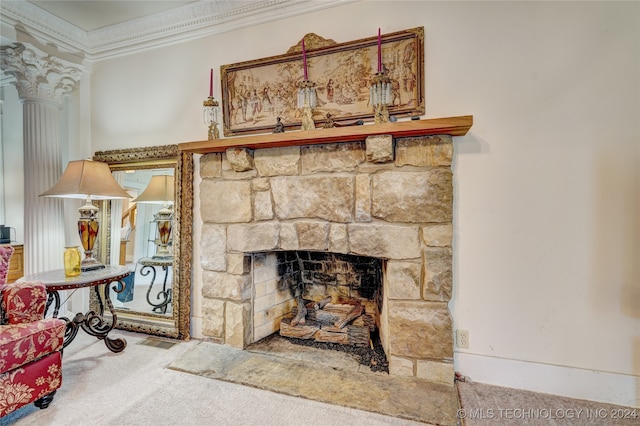 interior details featuring a fireplace, ornamental molding, carpet flooring, and decorative columns