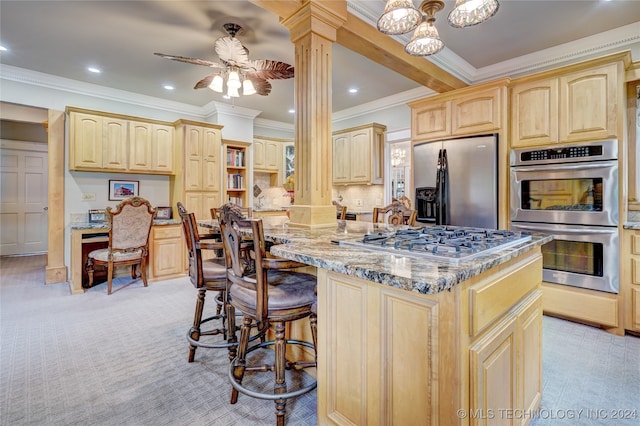 kitchen featuring ceiling fan, light colored carpet, decorative columns, light stone counters, and appliances with stainless steel finishes