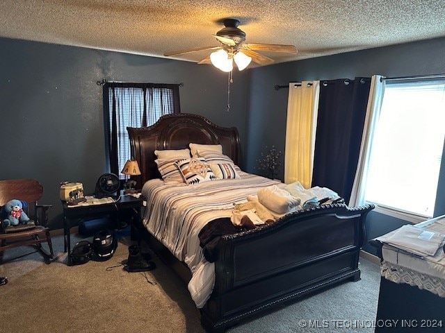 carpeted bedroom featuring a textured ceiling and ceiling fan