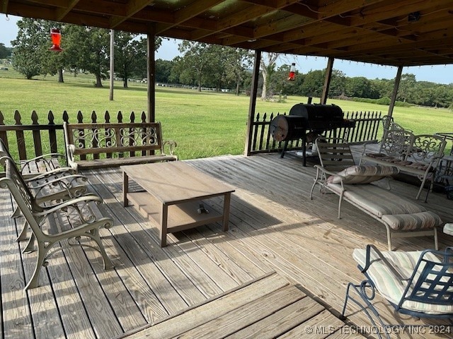 deck featuring a grill and a yard