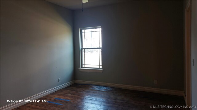 spare room with ceiling fan and dark hardwood / wood-style floors