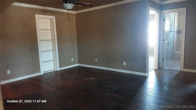 empty room featuring ornamental molding, ceiling fan, and dark hardwood / wood-style floors