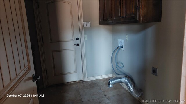 laundry room featuring hookup for a washing machine, hookup for an electric dryer, and cabinets