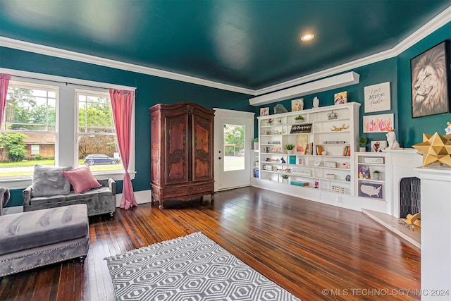 living area featuring ornamental molding and hardwood / wood-style floors