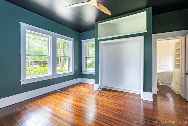 unfurnished bedroom with ceiling fan and wood-type flooring