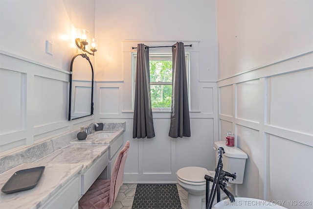 bathroom with tile patterned floors, vanity, and toilet