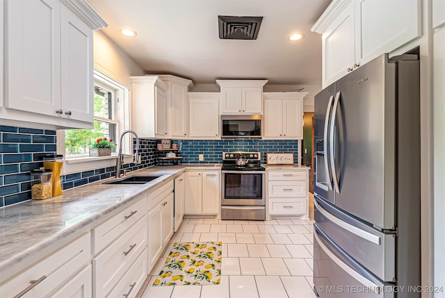 kitchen with stainless steel appliances, sink, and white cabinetry