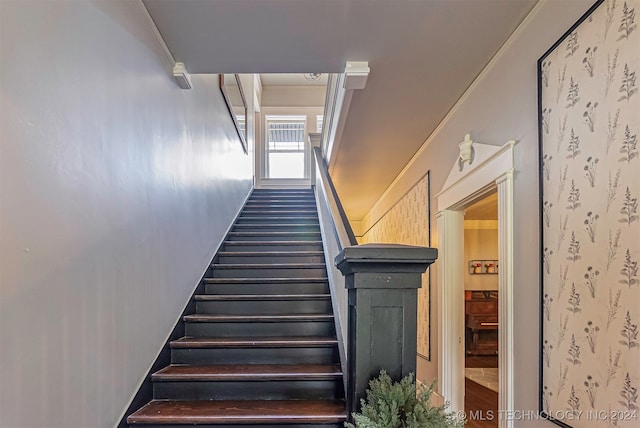 staircase featuring crown molding