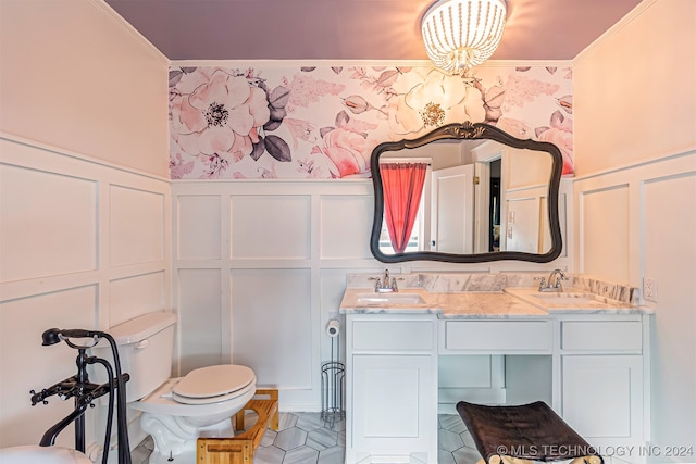 bathroom featuring crown molding, vanity, and toilet