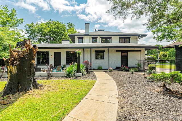 view of front of home featuring covered porch and a front yard