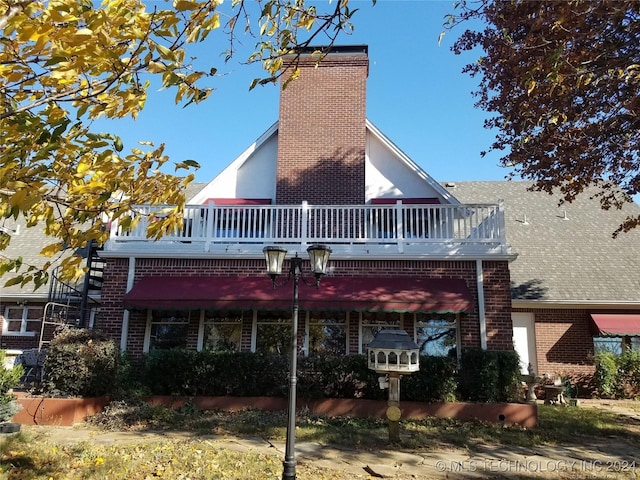 rear view of house with a balcony