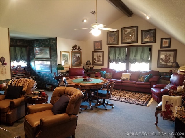 carpeted home office with ceiling fan and vaulted ceiling with beams