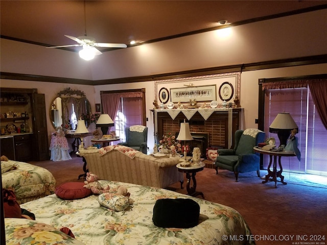 living room with a brick fireplace, crown molding, ceiling fan, and carpet