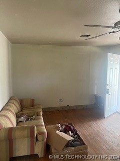 living room with wood-type flooring and ceiling fan