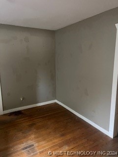 spare room featuring dark hardwood / wood-style floors