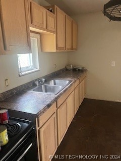 kitchen featuring black range with electric cooktop, light brown cabinets, sink, and dark tile patterned flooring