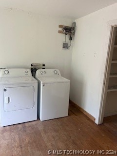 clothes washing area featuring independent washer and dryer and dark hardwood / wood-style flooring