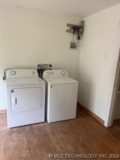 laundry room featuring dark hardwood / wood-style floors and washer and dryer