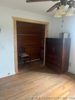 bedroom with a closet, light hardwood / wood-style floors, and ceiling fan