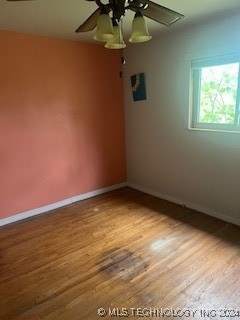 empty room with ceiling fan and hardwood / wood-style floors