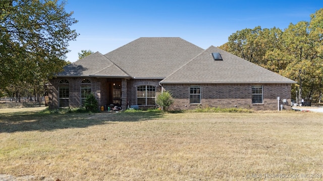 back of property featuring a lawn