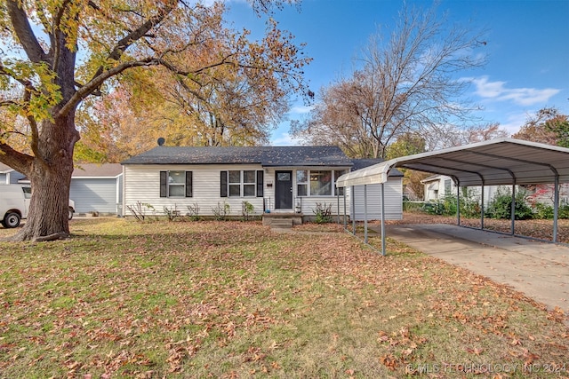 ranch-style home featuring a carport and a front yard