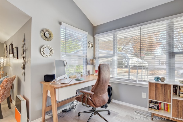 office with light hardwood / wood-style flooring, a wealth of natural light, and lofted ceiling