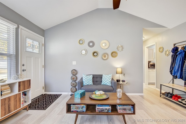 living room with light wood-type flooring and lofted ceiling with beams