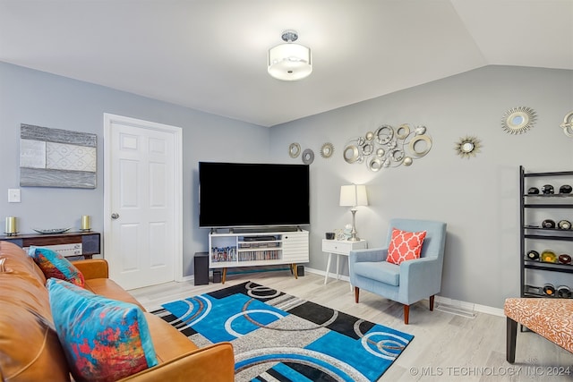 living room with hardwood / wood-style floors and lofted ceiling