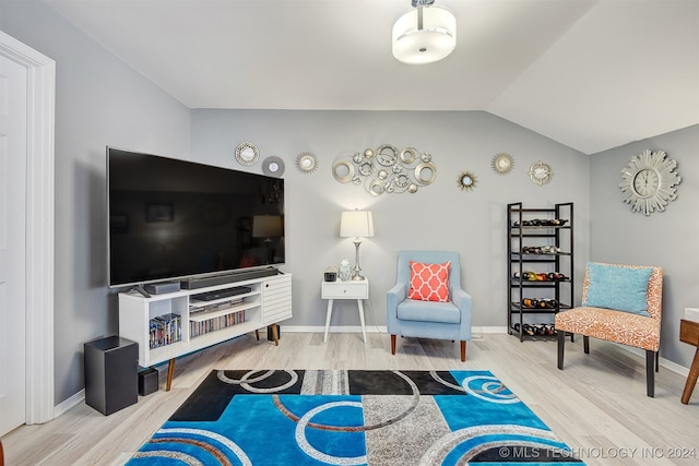 interior space with hardwood / wood-style floors and vaulted ceiling