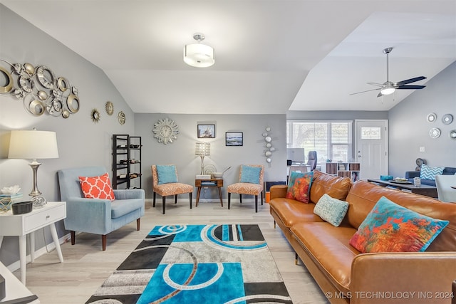 living room with ceiling fan, lofted ceiling, and light wood-type flooring