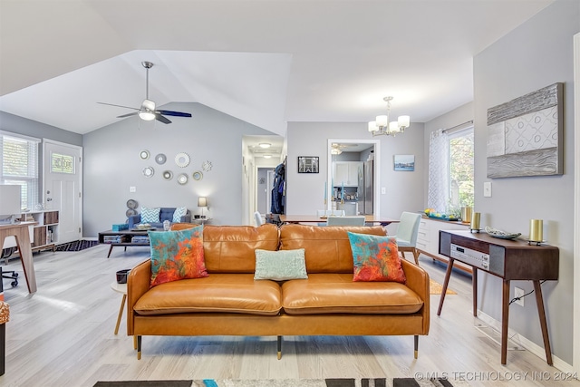 living room with vaulted ceiling, light hardwood / wood-style flooring, and ceiling fan with notable chandelier