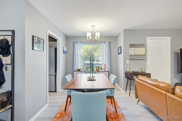 dining room featuring light hardwood / wood-style floors and an inviting chandelier