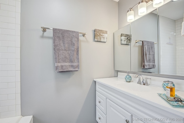 bathroom featuring vanity and a tile shower