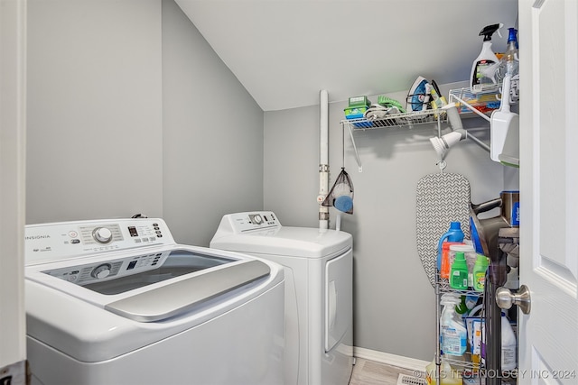 laundry room featuring washer and clothes dryer and wood-type flooring