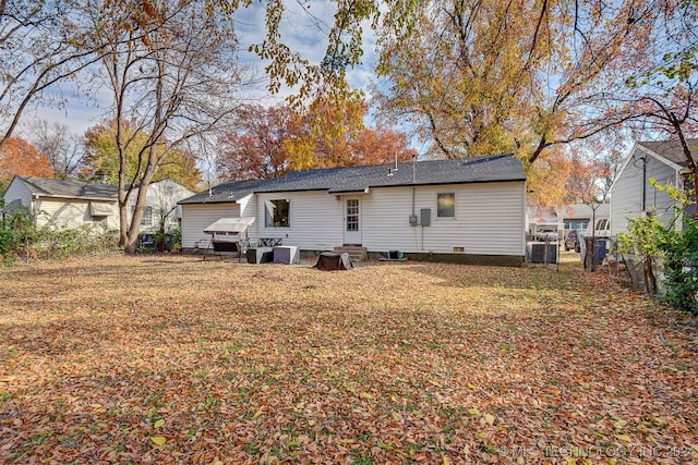 rear view of property with central AC